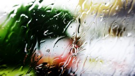 Rain falls on a car window