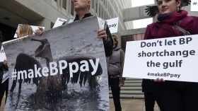 Activists protest in front of the Hale Boggs Federal Building on the first day of the trial over the Deepwater Horizon oil rig spill