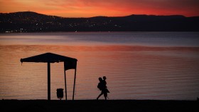 A man walks on the shore of the Sea of Galilee during sunset near the northern city of Tiberias October 29, 2012. 