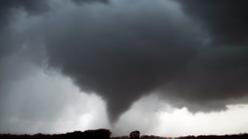 A tornado makes its way over the 135 freeway near Moundridge, Kansas, during the third day of severe weather and multiple tornado sightings, April 14, 2012