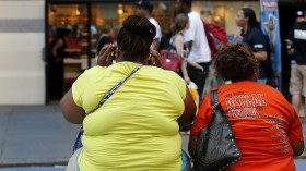 Women sit on a bench in New York's Times Square May 31, 2012