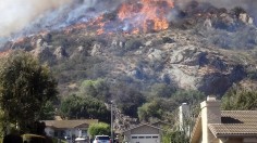 A fast moving brush fire approaches a home in the Camarillo Springs area of Ventura County, California May 2, 2013. 