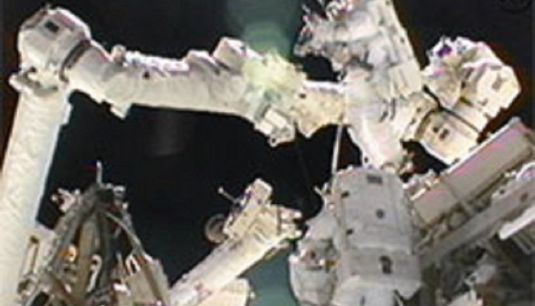 Spacewalkers Sunita Williams and Akihiko Hoshide work outside the International Space Station. 