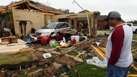 Pete Alaniz assesses the damage to the garage of his rental home that was destroyed by a tornado in Cleburne, Texas May 16, 2013.