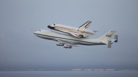 Space shuttle Endeavour, secured atop the modified 747 Shuttle Carrier Aircraft, takes to the skies after departure from NASA's Kennedy Space Center in Florida. 