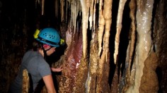 Georgia Tech Ph.D. candidate Stacy Carolin climbs through decorated cave chamber, Fairy City, within Clearwater Connection cave in Gunung Mulu National Park during a Fall 2012 field trip.