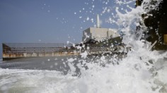 Chubu Electric Power Co.'s Hamaoka Nuclear Power Station is seen in the distance, as waves crash on a beach in Omaezaki, Shizuoka Prefecture May 17, 2013