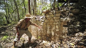 A National Institute of Anthropology and History (INAH) worker shows the remains of a building at the newly discovered ancient Maya city Chactun in Yucatan peninsula in this May 31, 2013 handout 