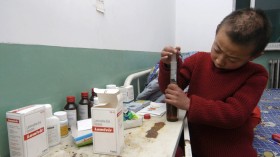 HIV-positive Child Prepares Medication