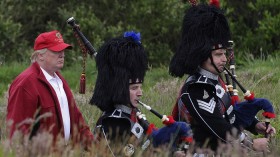 Real Estate magnate Donald Trump (L) follows bagpipers to the opening of his Trump International Golf Links golf course near Aberdeen, northeast Scotland July 10, 2012