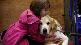 Girl Hugging a Dog