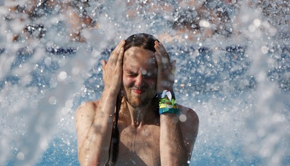 A man cools himself in a pool at the Palatinus outdoor spa in Budapest August 6, 2012.