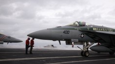 US Navy personnel works on the deck of the USS George Washington aircraft carrier off the coast of Brisbane July 23, 2013. 