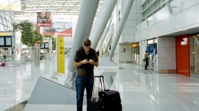 Traveler texting at the airport