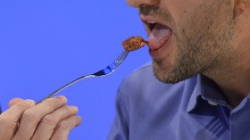 Josh Schonwald, a US-based food writer, tastes the world's first lab-grown beef burger during a launch event in west London August 5, 2013