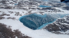 Frozen meltwater lake along the northeast Greenland coast
