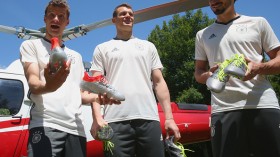  Thomas Mueller (L), Manuel Neuer and Mats Hummels (R) with their new Adidas football boots