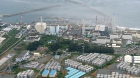 An aerial view shows the Tokyo Electric Power Co.'s (TEPCO) tsunami-crippled Fukushima Daiichi nuclear power plant and its contaminated water storage tanks (top) in Fukushima, in Aug. 31 photo 