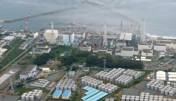 An aerial view shows the Tokyo Electric Power Co.'s (TEPCO) tsunami-crippled Fukushima Daiichi nuclear power plant and its contaminated water storage tanks (top) in Fukushima, in Aug. 31 photo 