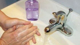 A person washes their hands with an antibacterial soap.