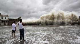 People watch waves hit the shores as Typhoon Usagi approaches in Shantou, Guangdong province, September 22, 2013. 