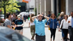 Tourists walk along 6th Avenue in Manhattan  in New York City. New Yorkers are experiencing high-than-normal temperatures as the the National Weather Service has issued a heat advisory in effect.