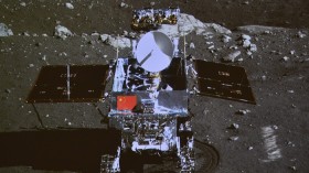 The image is a photograph of a screen at Beijing Aerospace Control Center showing lunar rover, taken by the camera on the Chang'e 3 probe.