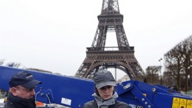 Customs agents hold ivory tusks which will be pulverized into dust during the exhibition of around three tonnes of illegal ivory seized by French customs agents in front of the Eiffel tower in Paris