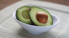 Halved Avocado in a White Bowl (IMAGE)