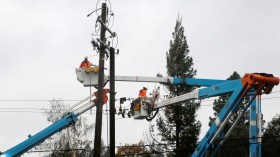 FILE PHOTO: PG&E crew work on power lines to repair damage caused by the Camp Fire in Paradise, California
