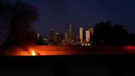 A car burns after catching on fire along the side of the 101 highway in Los Angeles