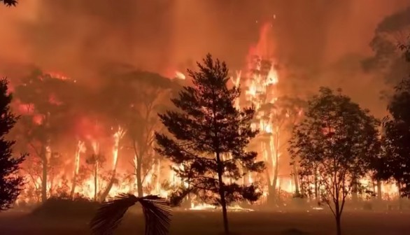 A fire blazes across bush as seen from Mount Tomah in New South Wales