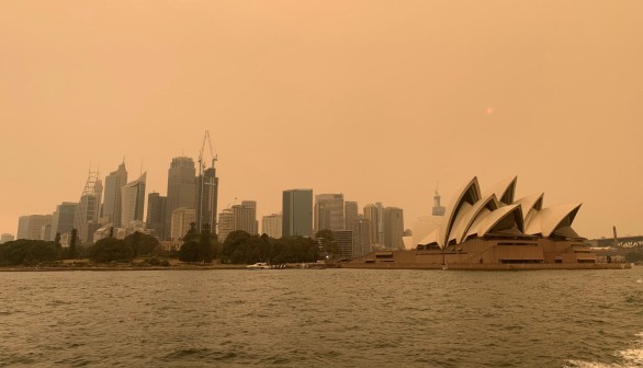 FILE PHOTO: The haze from bushfires obscures the sun setting above the Sydney Opera House in Sydney