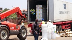 workers from Doctors Without Borders unload emergency medical supplies to deal with an Ebola outbreak in Conakry, Guinea, March 23, 2014. 