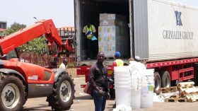 workers from Doctors Without Borders unload emergency medical supplies to deal with an Ebola outbreak in Conakry, Guinea, March 23, 2014. 