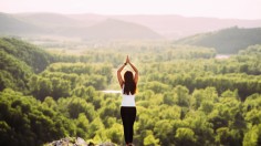 Girl doing yoga at sunset.