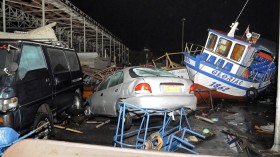 Vehicles and boats lie on the shore after a tsunami hit the northern port of Iquique, April 2, 2014. 