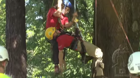 Image is a screenshot from a promotional competitive tree climbing video published by the International Society of Arboriculture