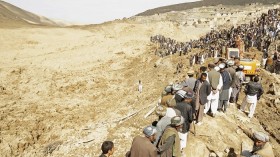 A village in Afghanistan turned into a mass grave Friday after a series of rain-induced landslides left more than 2,000 dead. 