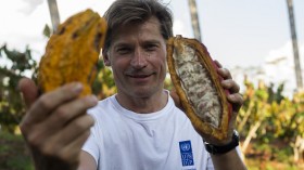 A man holding cocoa pods