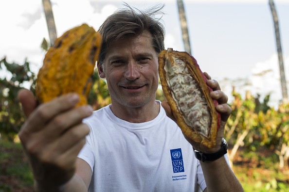 A man holding cocoa pods