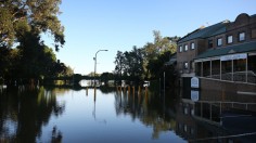 A semi-submerged building in floodwaters