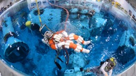 Steve Bowen is lowered into the Neutral Buoyancy Laboratory at Johnson Space Center