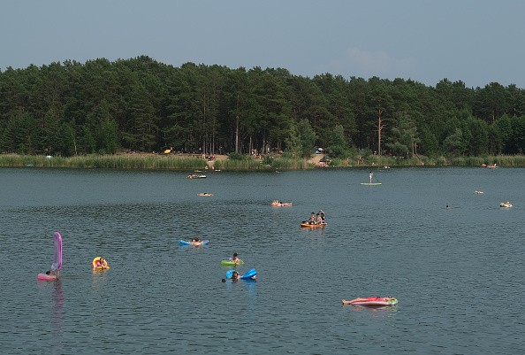 People Cooling off in the lake due to the hot temperature