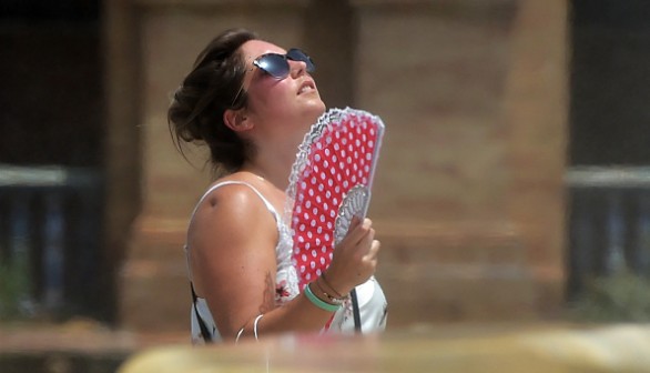 woman cools off faning herself due to the heat