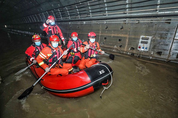  Rescuers searching inside the subway flooded by heavy rains in Zhengzhou,