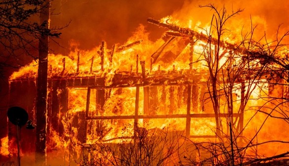 A home is consumed by flames as the Dixie fire rages on in Greenville, California