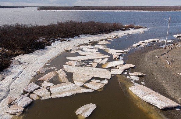 Melting ice beside severe erosion of a permafrost 