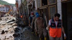 Soldiers and rescuers arrive to help clear the debris after the Ezine river broke it's banks during flash floods in Bozkurt 