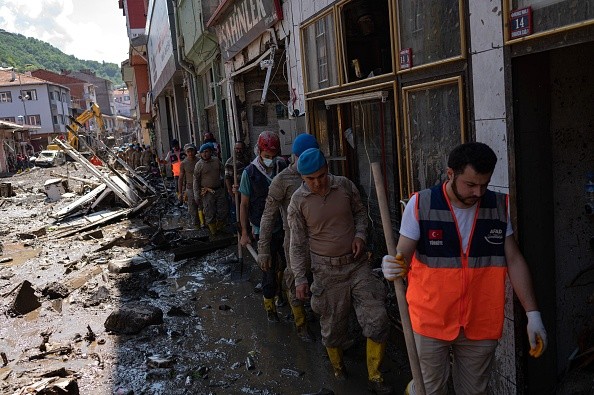 Soldiers and rescuers arrive to help clear the debris after the Ezine river broke it's banks during flash floods in Bozkurt 